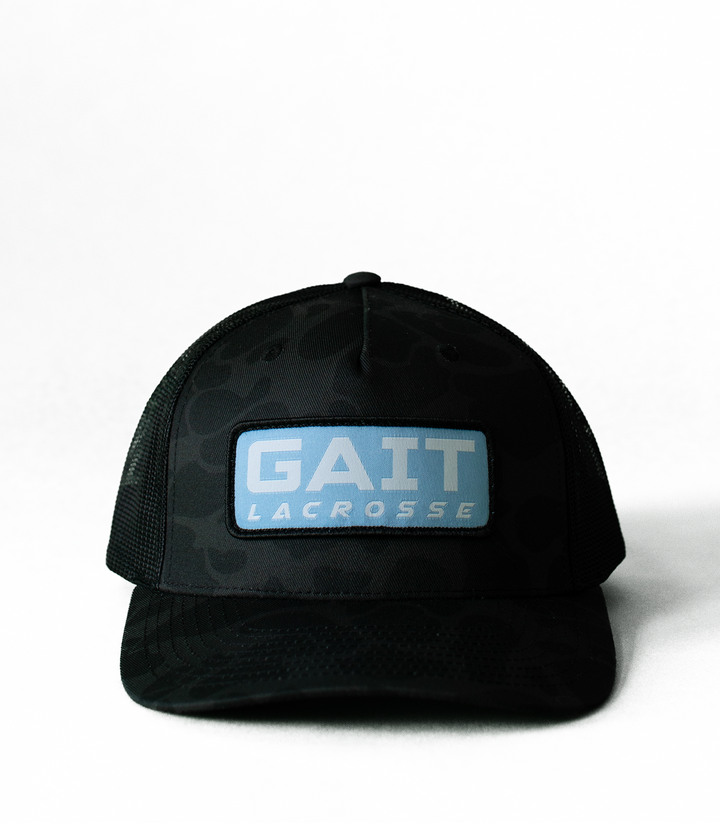 Black Camo Light Blue Patch Trucker Hat
